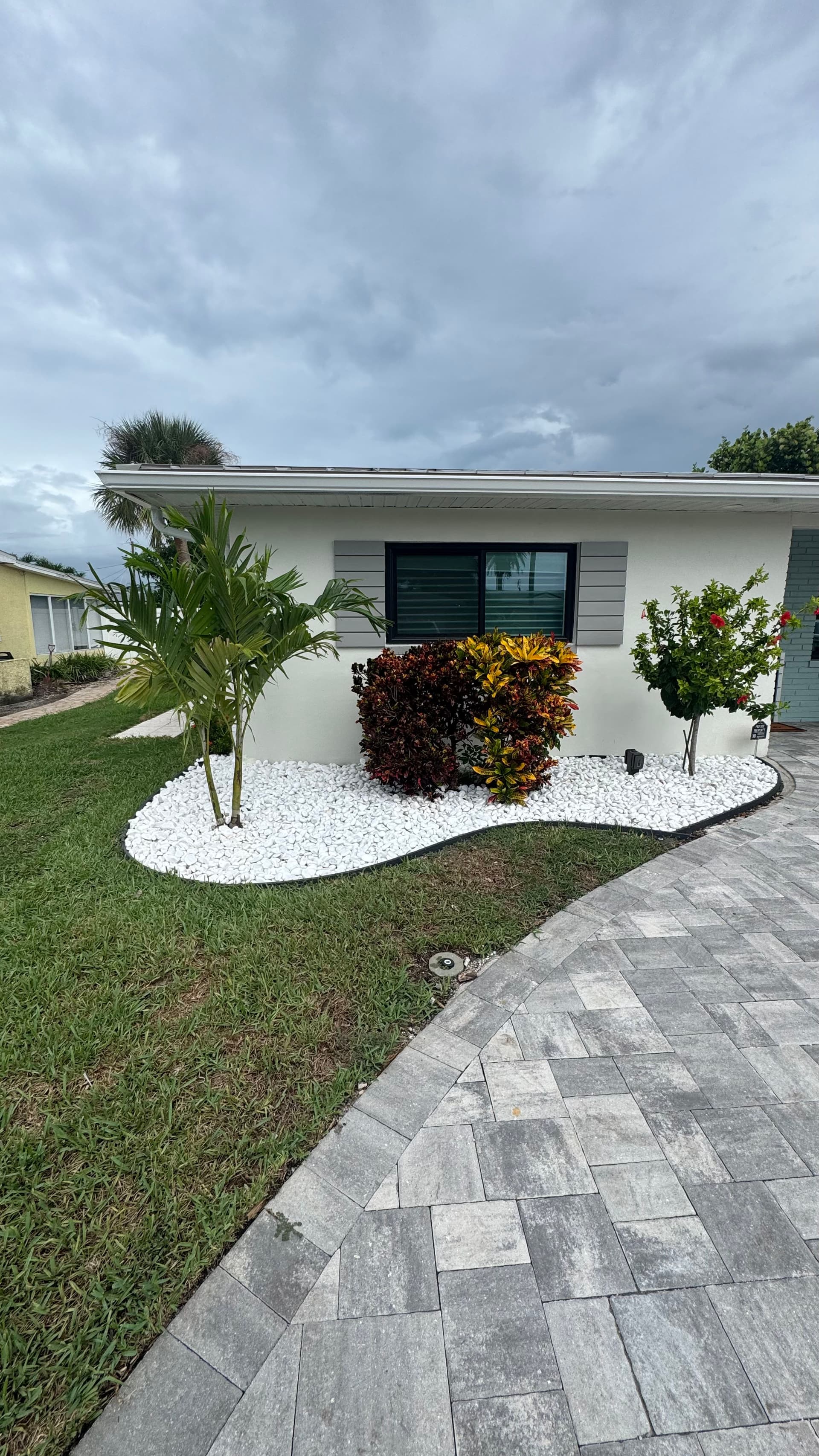 Front Yard Upgrade With Palms, Ixora, and Caribbean Beach Pebbles image