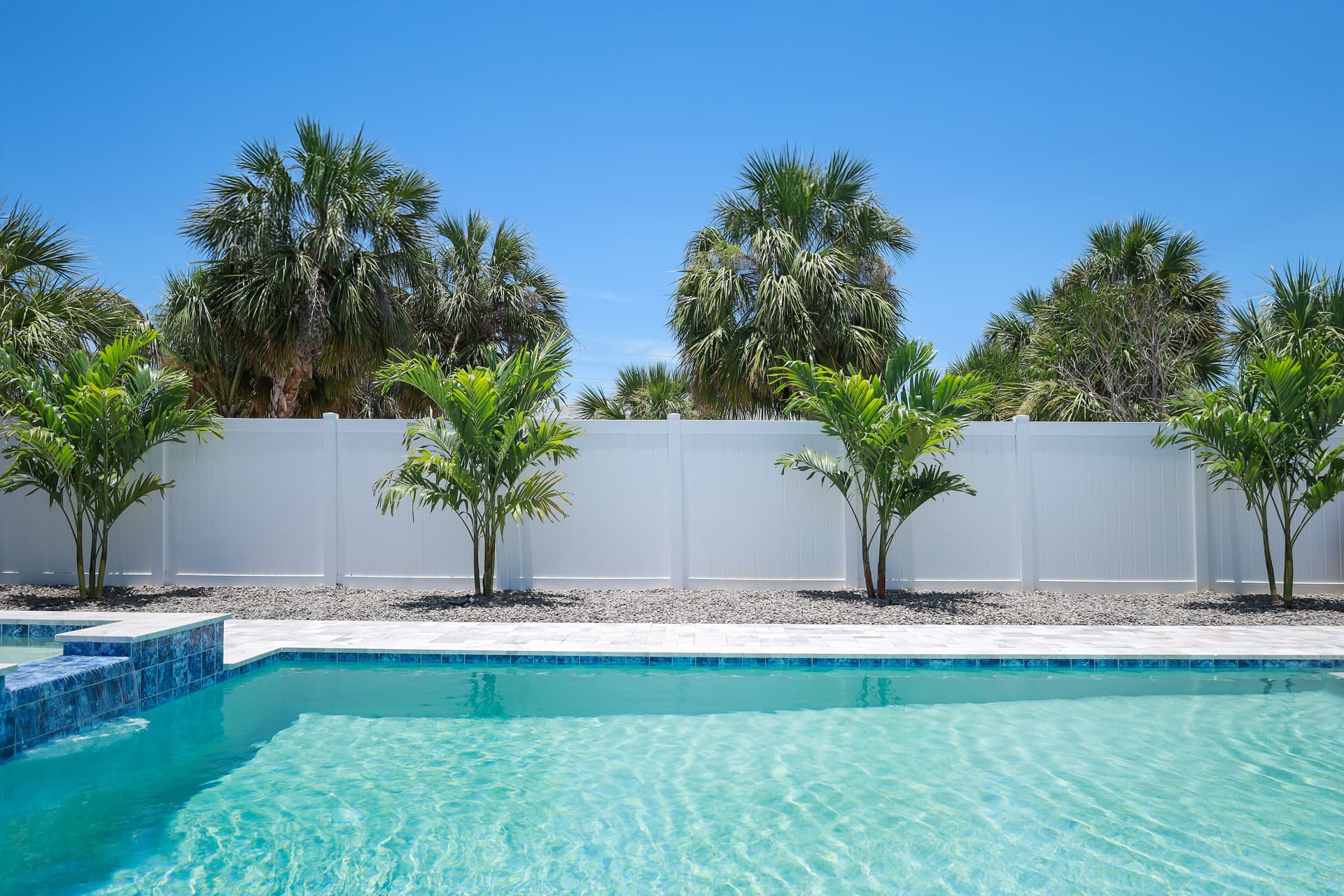 Palm Trees and River Rock Finish This Pool the Right Way image